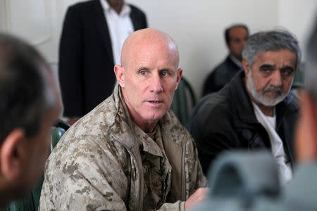 FILE PHOTO: Vice Adm. Robert S. Harward, commanding officer of Combined Joint Interagency Task Force 435, speaks to an Afghan official during his visit to Zaranj, Afghanistan, in this January 6, 2011 handout photo. The visit consisted of a tour of a provincial prison, the Iran/Afghanistan border crossing and an airfield assessment. Sgt. Shawn Coolman/U.S. Marines/Handout via REUTERS