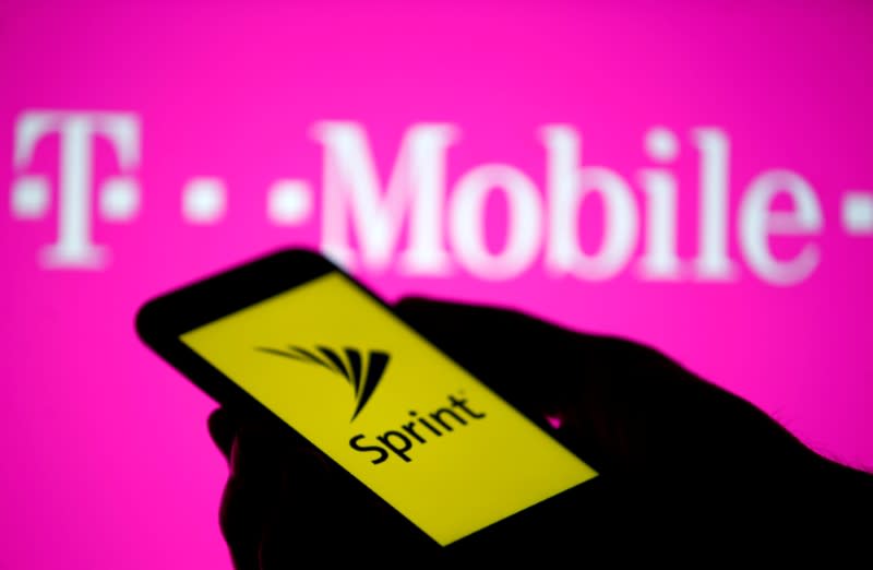 FILE PHOTO: A smartphone with Sprint logo are seen in front of a screen projection of T-mobile logo, in this picture illustration