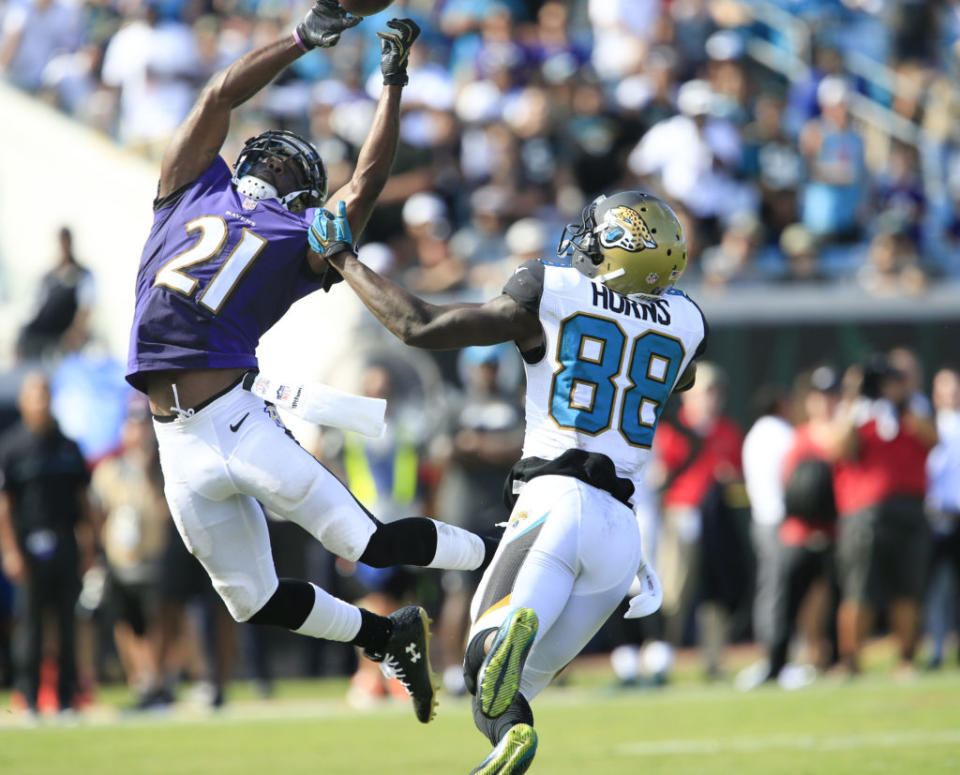 Sep 25, 2016; Jacksonville, FL, USA; Baltimore Ravens free safety Lardarius Webb (21) tips the ball to his teammate causing an interception as Jacksonville Jaguars wide receiver Allen Hurns (88) looks on during the second half of a football game at EverBank FieldThe Baltimore Ravens won 19-17. Mandatory Credit: Reinhold Matay-USA TODAY Sports