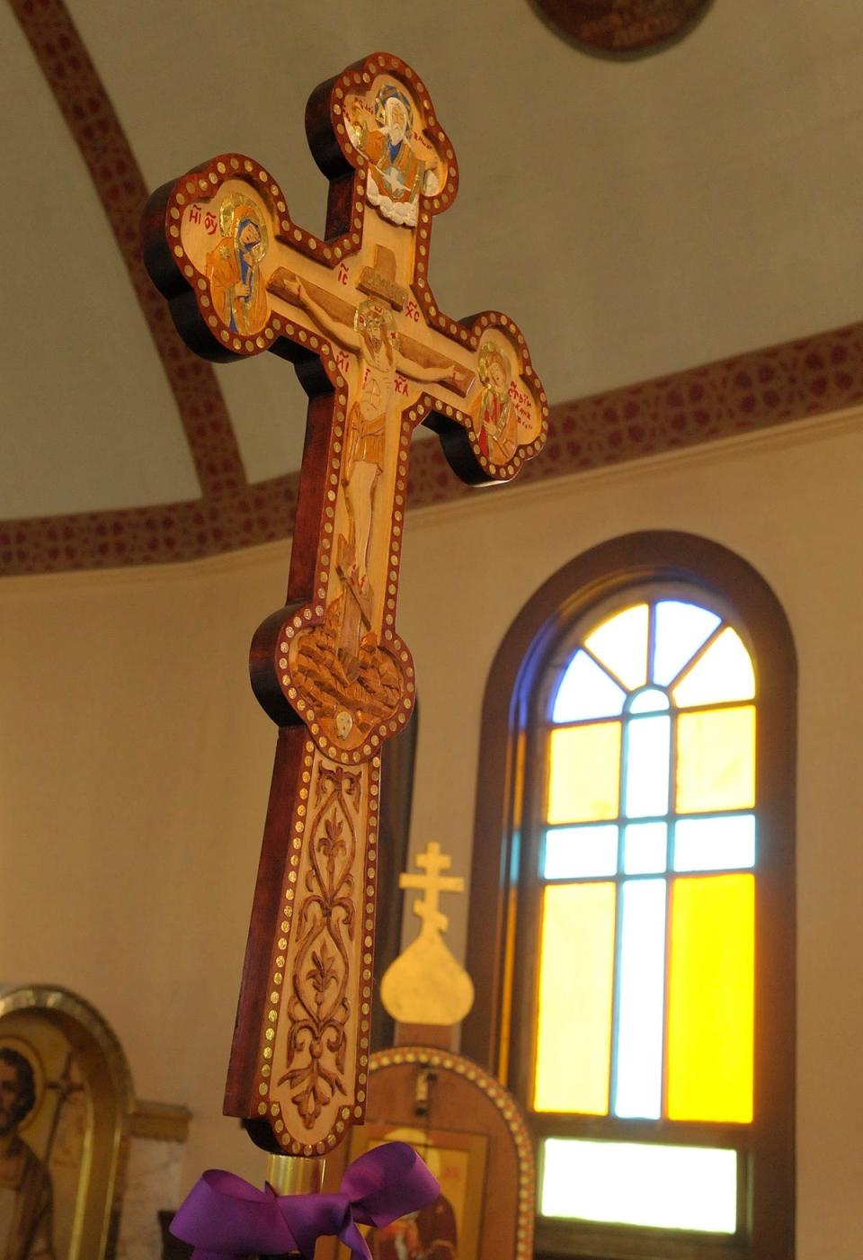 An ornate wooden cross is seen in the sanctuary of St. John the Baptist Ukrainian Catholic Church in 2014.