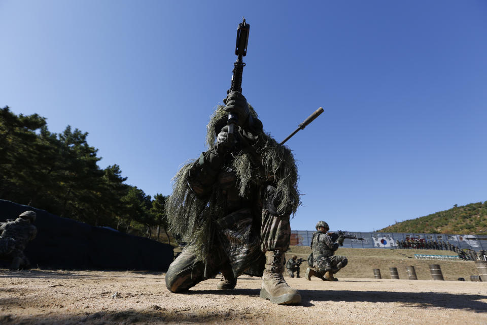 South Korean marines secure an area during their regular drill on Yeonpyeong Island, South Korea Thursday, Nov. 1, 2018. The U.S. and South Korea are reviewing whether they will conduct large-scale military exercises next year and will decide before December. South Korean Defense Minister Jeong Kyeong-doo told reporters Wednesday at the Pentagon that if more exercises are suspended the two countries will conduct other training to mitigate the lapse. He says the review will be done by Nov. 15. (Jeon Heon-kyun/Pool Photo via AP)