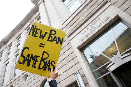 FILE PHOTO - Immigration activists, including members of the DC Justice for Muslims Coalition, rally against the Trump administration's new ban against travelers from six Muslim-majority nations, outside of the U.S. Customs and Border Protection headquarters in Washington, U.S. on March 7, 2017. REUTERS/Eric Thayer/File Photo