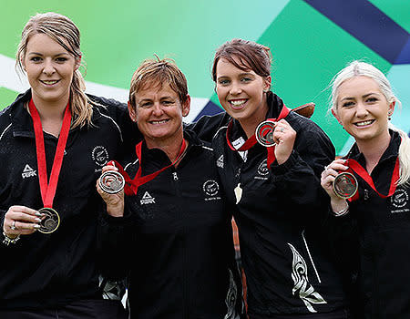 Mandy Boyd, Val Smith, Amy McIlroy and Selina Goddard of New Zealand pose after winning the Women's Fours bronze medal match.