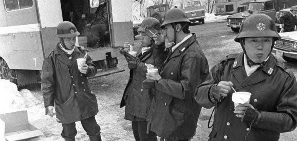 Men in uniform linger and eat.