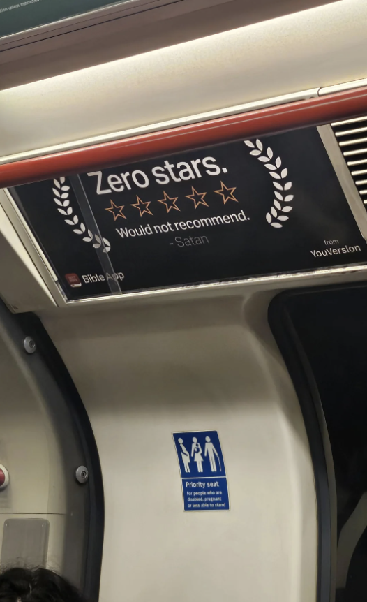 Advertisement showing a humorous review of "Zero stars. Would not recommend." attributed to Satan for the Bible App from YouVersion