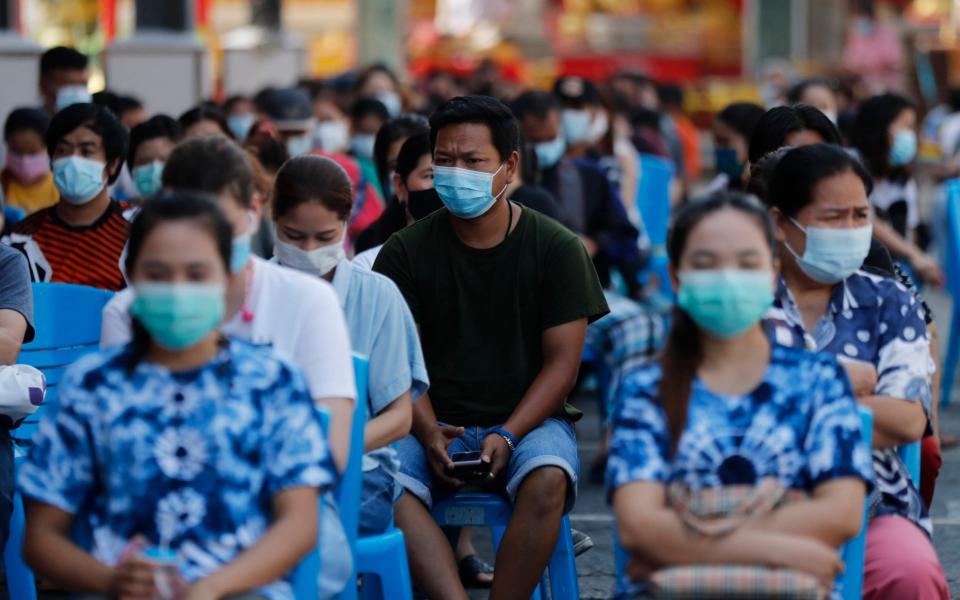 People wait for the the Sinovac COVID-19 vaccination in Bangkok, Thailand, Monday, April 12, 2021 - AP