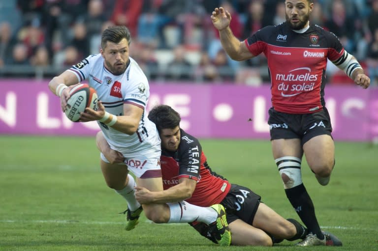 Bordeaux-Begles' Australian wing Adam Ashley-Cooper (L) is tackled by RC Toulon's French flyhalf Pierre Bernard (C) during the French Top 14 rugby union match RC Toulon vs Union Bordeaux-Begles on December 4, 2016