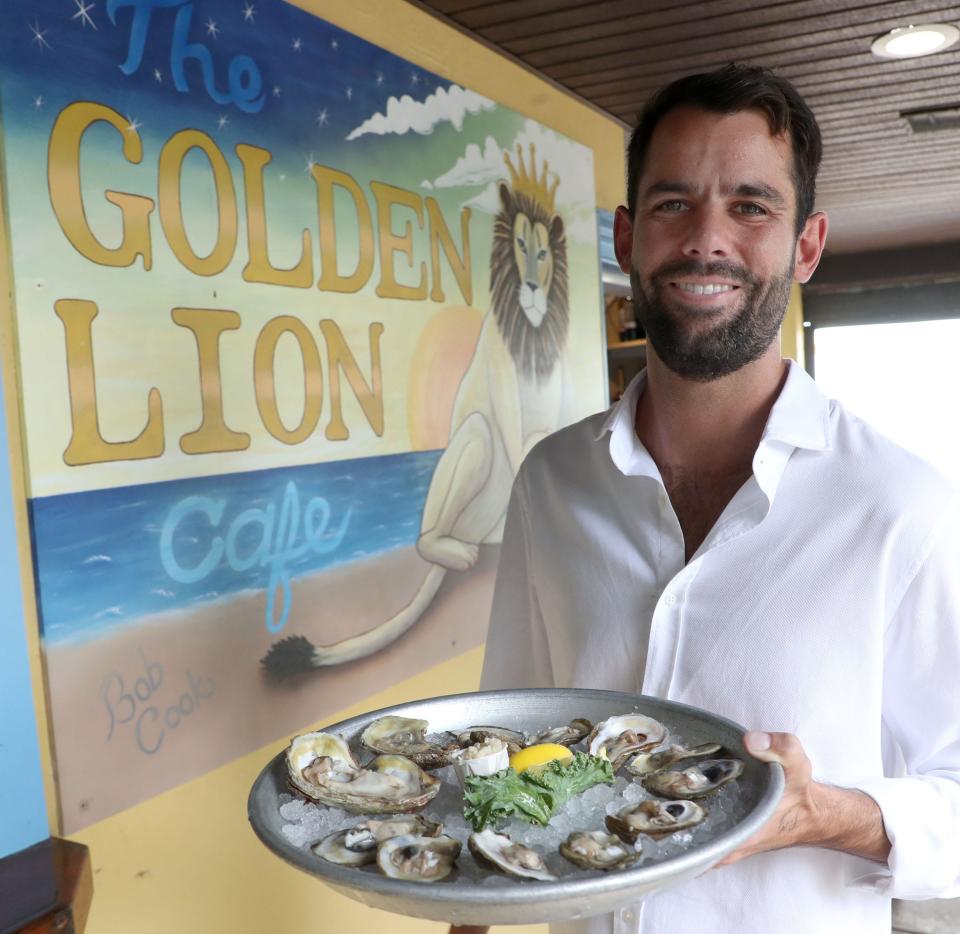 Owner Christopher Marlow shows off a plate of oysters at the Golden Lion Cafe in Flagler Beach. After growing up in the family-owned restaurant, Christopher has stepped into a leadership role.