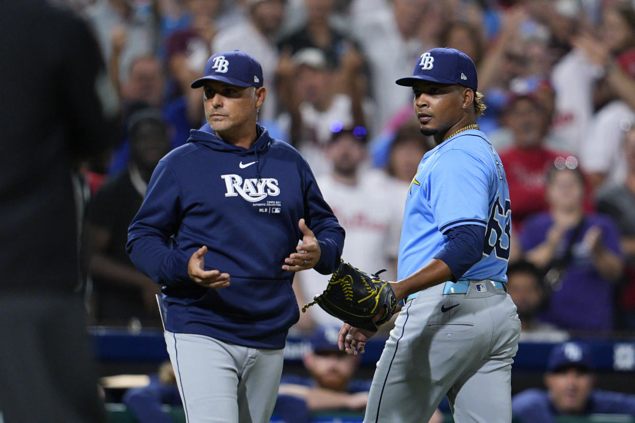 Tampa Bay Rays' Edwin Uceta, right, walks off the field after he was ejected for hitting Philadelphia Phillies' Nick Castellanos during the eighth inning of a baseball game, Tuesday, Sept. 10, 2024, in Philadelphia. (AP Photo/Derik Hamilton)