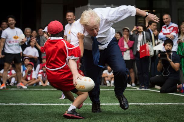 PHOTO: London Mayor Boris Johnson takes part in a game of rugby with children and adults on a street in Tokyo, Oct. 15, 2015, to mark Japan being chosen to host the 2019 Rugby World Cup. (Stefan Rousseau/PA via AP, File)