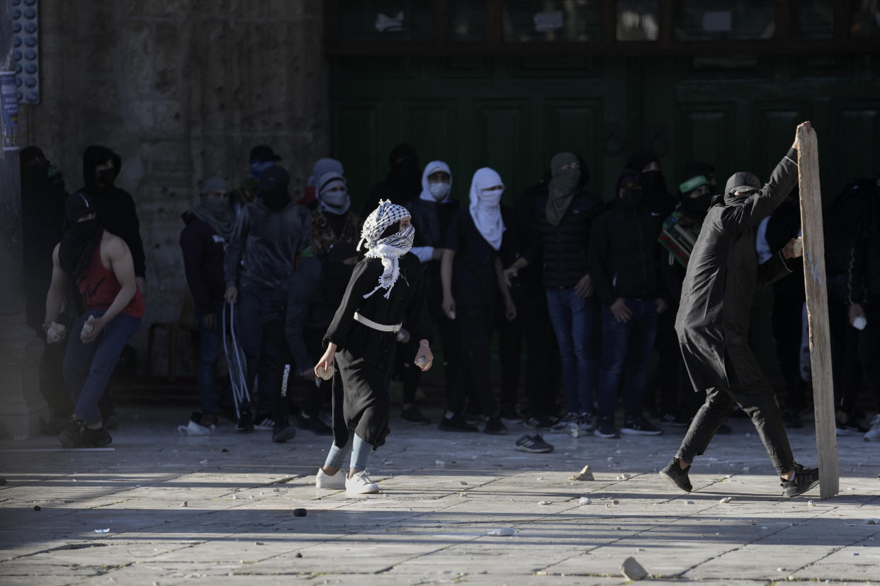 Palestinians clash with Israeli security forces at the Al Aqsa Mosque compound in Jerusalem's Old City Friday, April 15, 2022. (AP Photo/Mahmoud Illean)