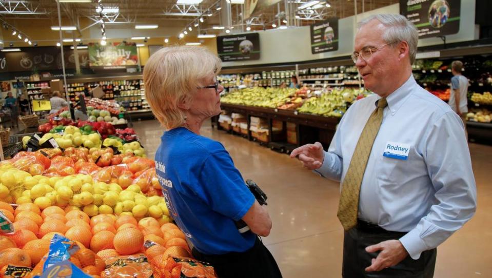 Kroger CEO Rodney McMullen, right, speaks with associate Cheri Vandervort in the produce section of the Oakley Kroger Marketplace in Cincinnati.