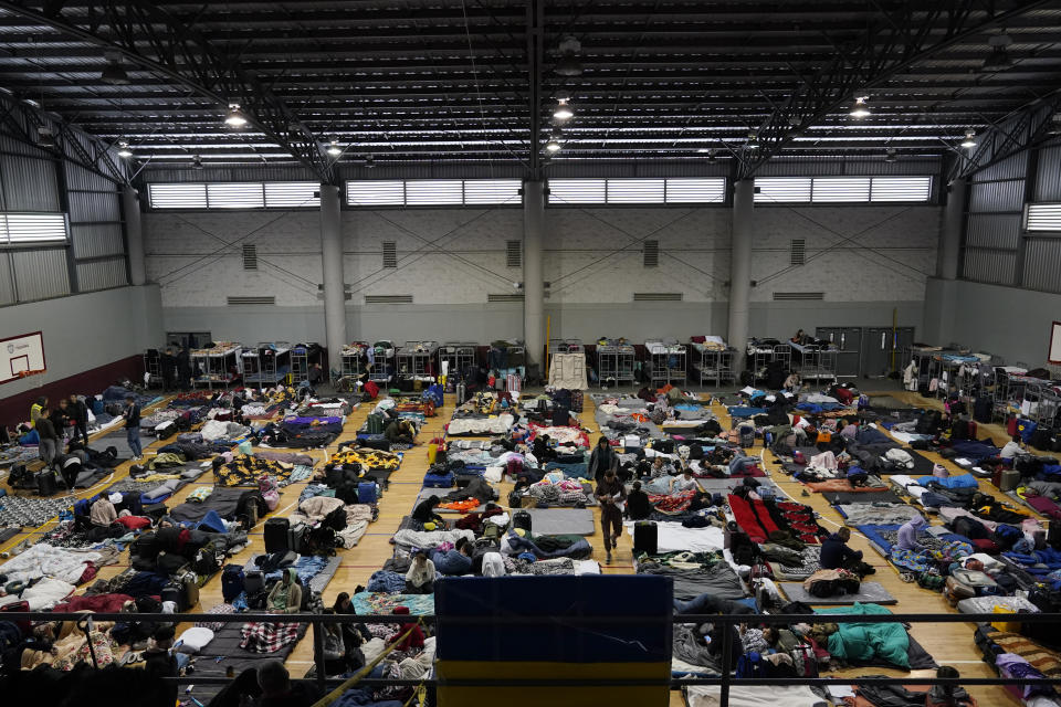 FILE - Ukrainian refugees wait in a gymnasium in Tijuana, Mexico, April 5, 2022. Hundreds of Ukrainian refugees arrived daily to this Mexican border city, where they waited two to four days for U.S officials to admit them on humanitarian parole. (AP Photo/Gregory Bull, File)
