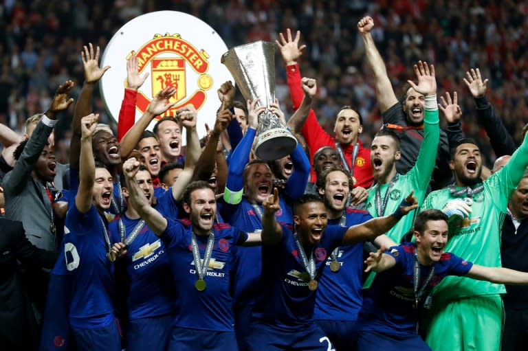 Manchester United's players celebrate with the Europa league trophy after winning their final against Ajax Amsterdam on May 24, 2017 at the Friends Arena in Solna outside Stockholm