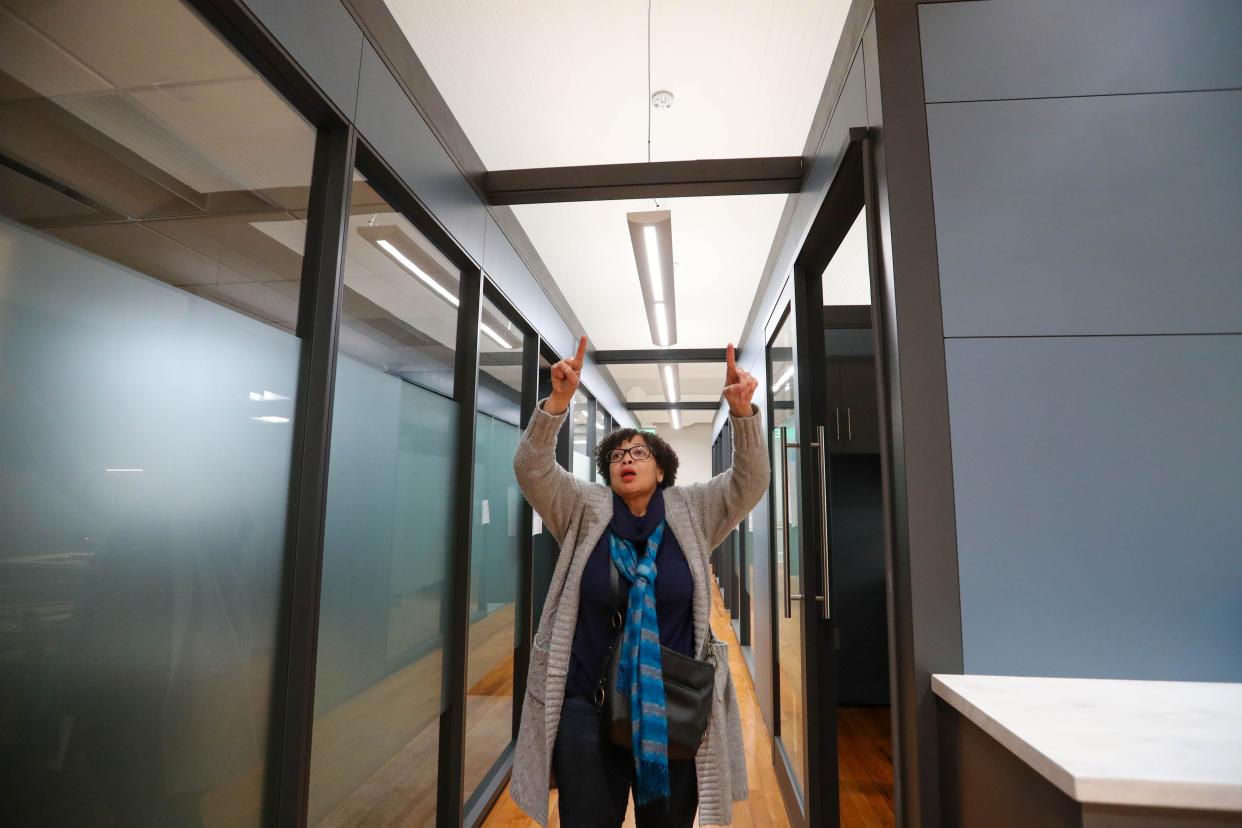 Michelle Owens, interim Tybee Island City Manager, points out the high ceiling among the moveable DIRTT office system that has been added in the former theatre at the Tybee Island City Hall. An old drop ceiling was removed during renovations to expose the original high ceilings.