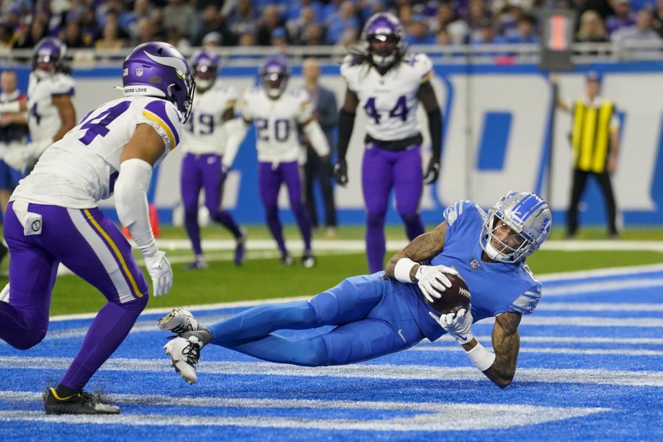 Detroit Lions' Josh Reynolds catches a touchdown pass during the second half of an NFL football game against the Minnesota Vikings Sunday, Dec. 11, 2022, in Detroit. (AP Photo/Paul Sancya)