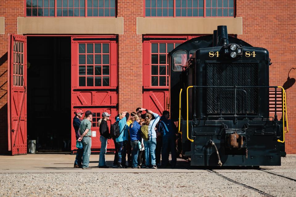 Scouts learn about a diesel locomotive during the railroad merit badge program Saturday at the Age of Steam Roundhouse Museum in Sugarcreek.