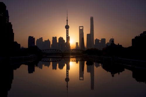 TOPSHOT - The sun rises behind the skyline of Shanghai in the Lujiazui Financial District of Pudong on November 11, 2016. / AFP PHOTO / JOHANNES EISELEJOHANNES EISELE/AFP/Getty Images