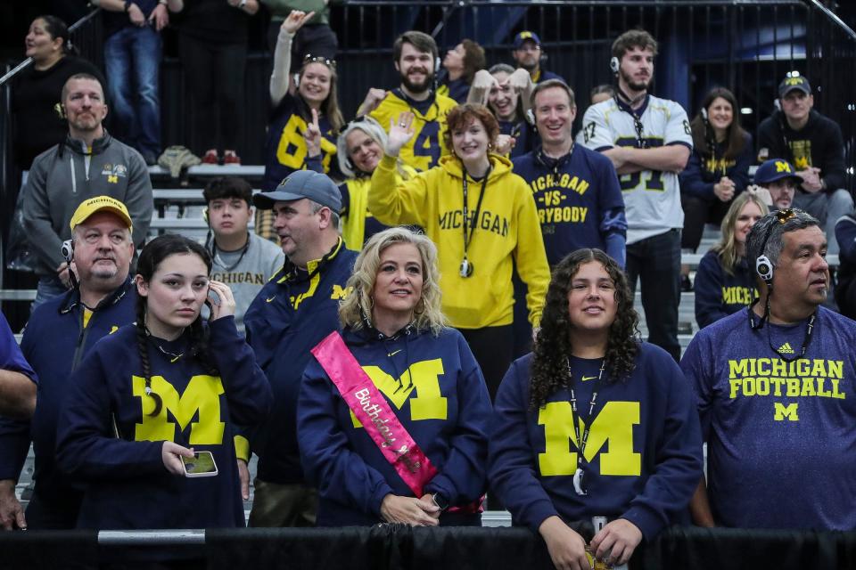 Michigan fans cheer for players and coaches during national championship game media day at George R. Brown Convention Center in Houston, Texas on Saturday, Jan. 6, 2024.