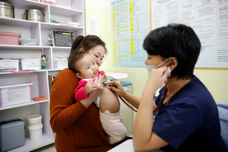 FILE PHOTO: Ulzii-Orshikh Otgon visits a doctor for her daughter, diagnosed with pneumonia, at a children's hospital in Bayangol