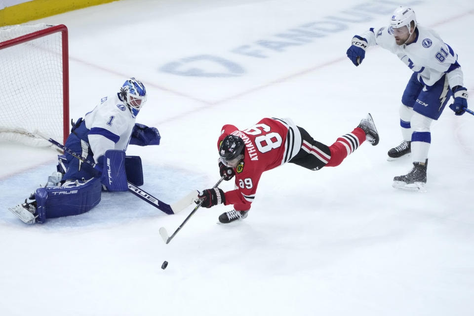 Chicago Blackhawks' Andreas Athanasiou is unable to get a shot off as Tampa Bay Lightning goaltender Brian Elliott and Erik Cernak defend during the first period of an NHL hockey game Tuesday, Jan. 3, 2023, in Chicago. (AP Photo/Charles Rex Arbogast)