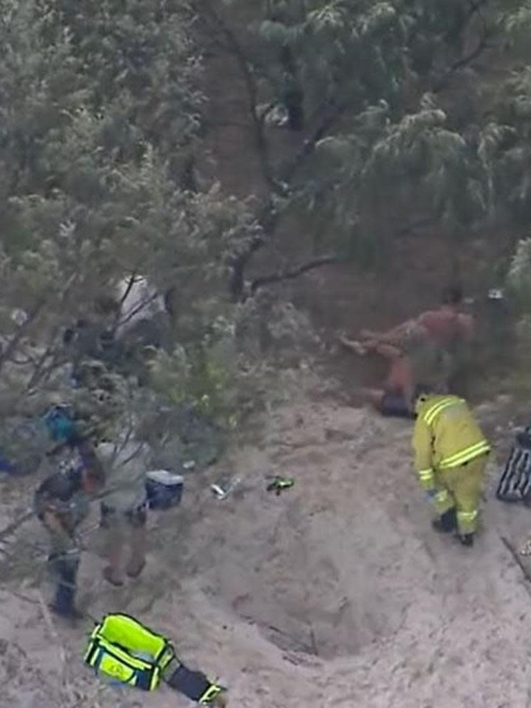 Queensland Paramedics and an RACQ Lifeflight rescue helicopter crew were called to help a 25-year-old man after he fell into a hole and was buried in sand on Bribie Island, north of Brisbane. Picture: NineNews