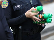 <p>Michelle Albelo, A City of Miami police officer, gives out cans of insect repellent to help people near the Miami Rescue Mission prevent mosquito bites that may infect them with the Zika virus on August 2, 2016 in Miami, Fla. (Joe Raedle/Getty Images)</p>