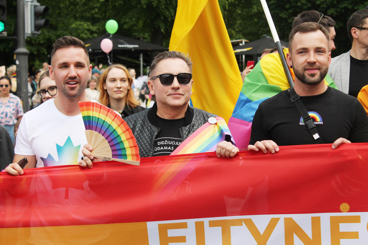 Image: Mayor Colin Ratushniak of LaRoche, Canada, left, Vladimir Simonko and Tomas Raskevičius at the Baltic Pride march in Vilnius, Lithuania, on June 5, 2022. (Enrique Anarte Lazo)