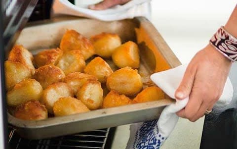 Roast potatoes coming out of the oven