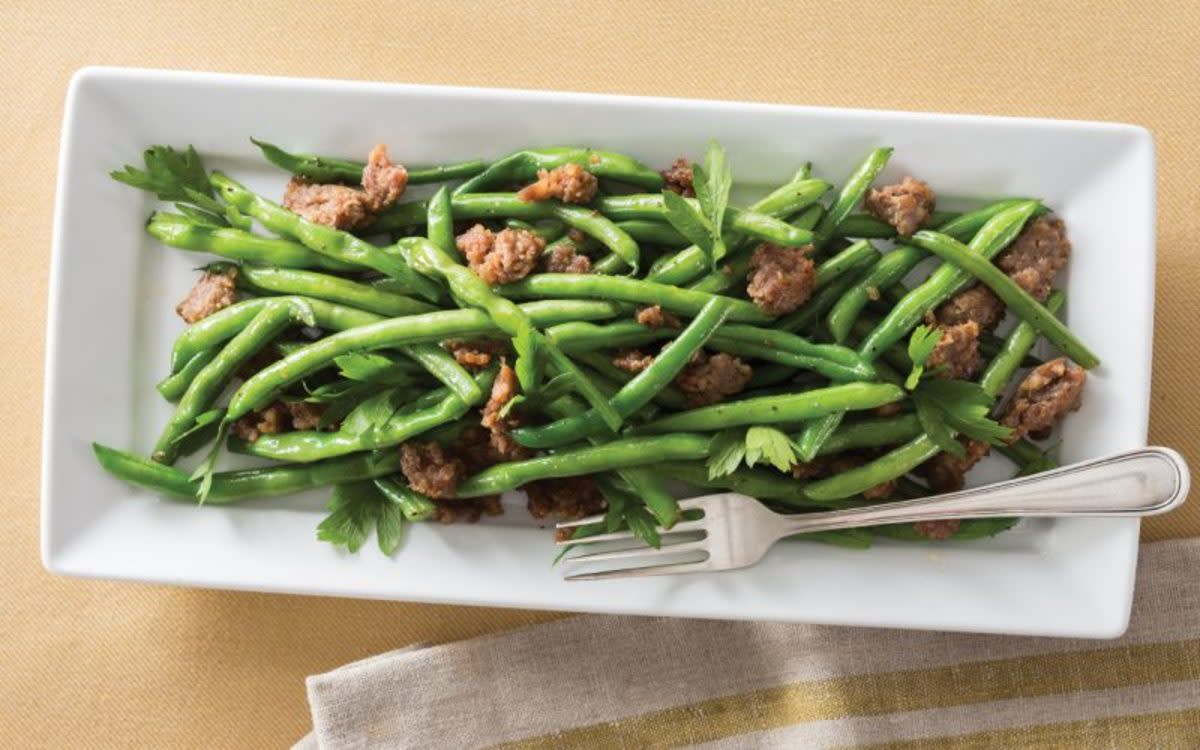 <p>Parade</p><p>Just four ingredients transform green beans into a sweet-and-salty delight that can be made from start to finish on a baking sheet.</p><p><strong>Get the Recipe: <a href="/842515/communitytable/maple-roasted-green-beans-with-sausage/" data-ylk="slk:Maple Roasted Green Beans with Sausage;elm:context_link;itc:0;sec:content-canvas" class="link rapid-noclick-resp">Maple Roasted Green Beans with Sausage</a></strong></p>