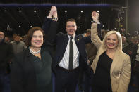 Sinn Fein's John Finucane celebrates with party leader Mary Lou McDonald, left, and deputy leader Michelle O'Neill after winning in the Belfast North constituency at the Titanic exhibition centre, Belfast, Northern Ireland for the 2019 general election, Friday Dec. 13, 2019. (Liam McBurney/PA via AP)