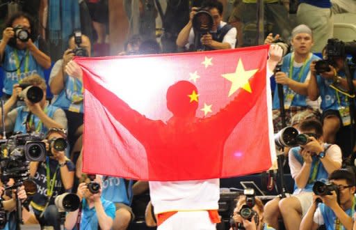 China's gold medalist Sun Yang holds the national flag as he poses for photos during the award ceremony for the final of the men's 1500m freestyle swimming event at the FINA World Championships in Shanghai, in 2011. Sun smashed Grant Hackett's 10-year-old 1,500m world record last year and currently ranks number one in the 400m, 800m and 1,500m