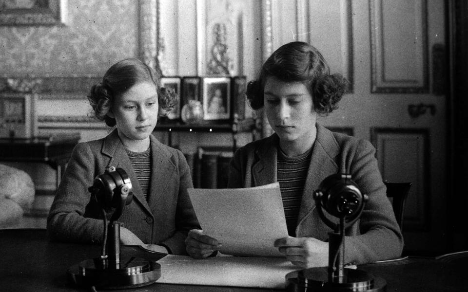 Princess Elizabeth (later Queen Elizabeth II), right, broadcasting with her sister Princess Margaret alongside. - Popperfoto via Getty Images