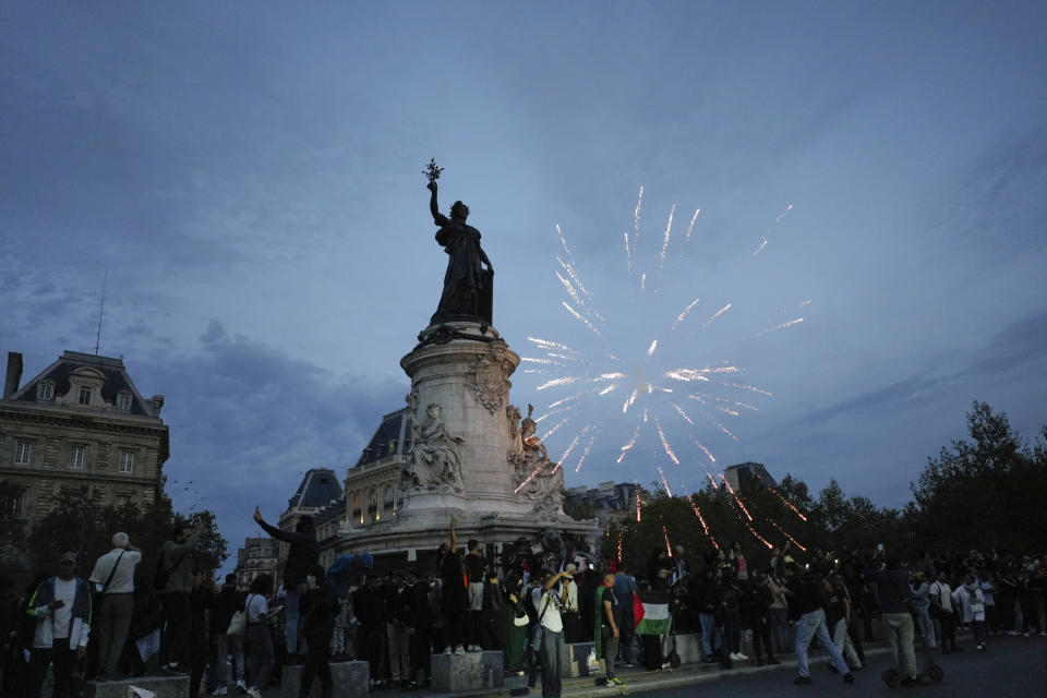 Protestors use fireworks during a rally in solidarity with the Palestinian people in Gaza, in Paris, Thursday, Oct.12, 2023. (AP Photo/Thibault Camus)