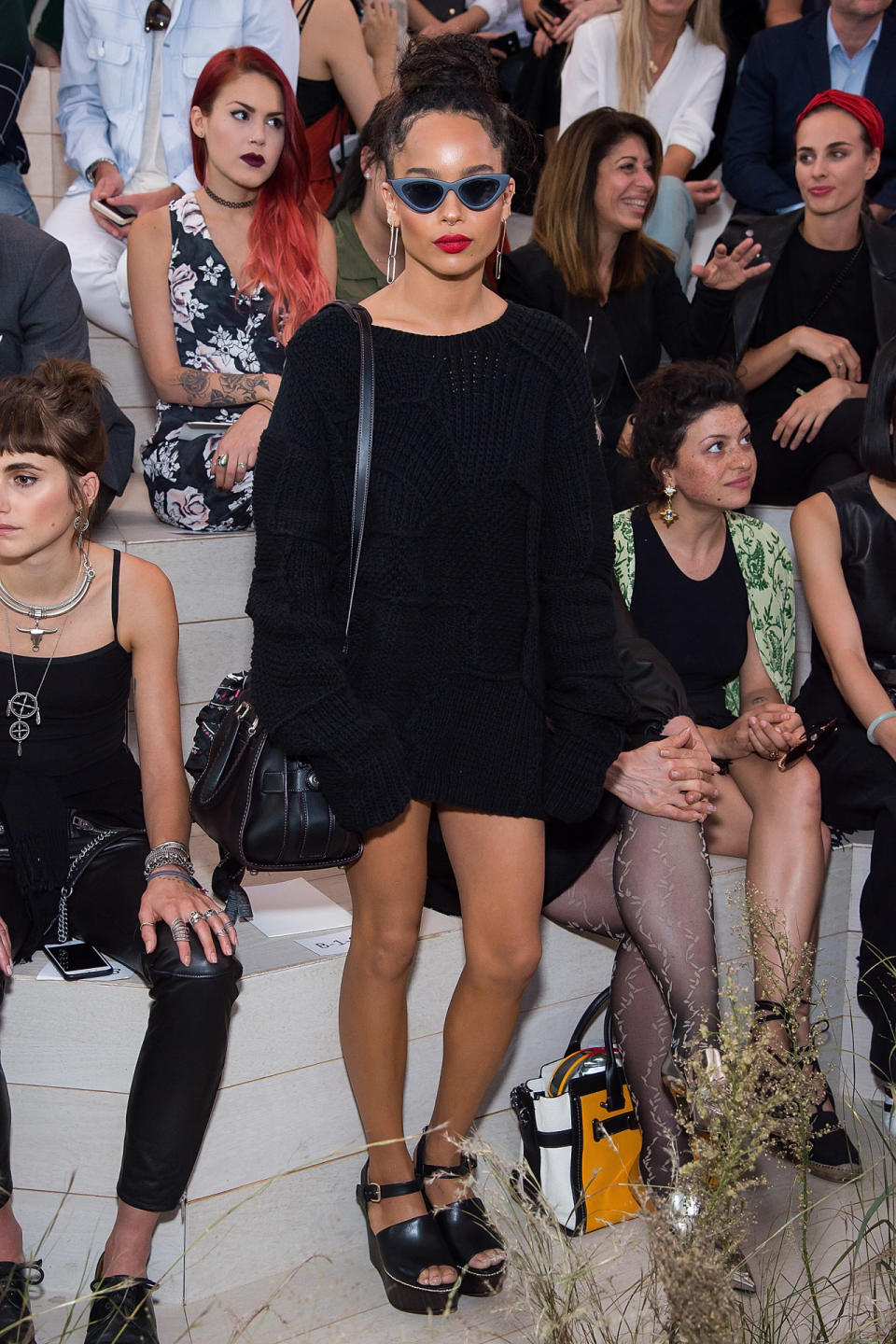 Zoe Kravitz in an oversized black patchwork Coach knit sweater.