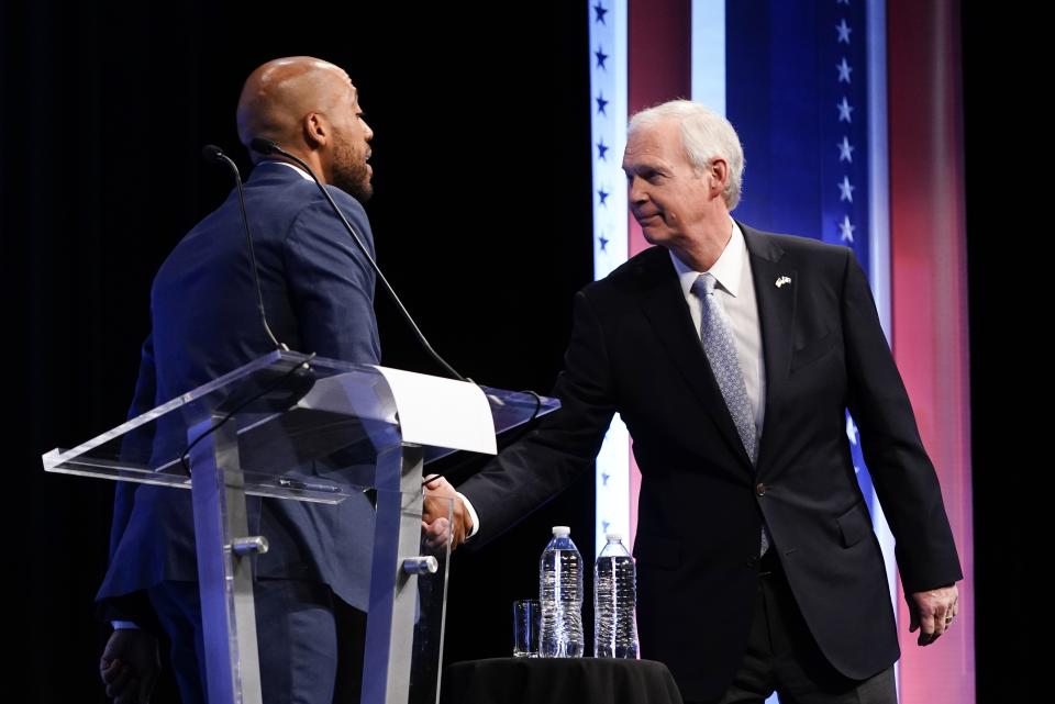 Republican U.S. Senate candidate Ron Johnson, right, and Democratic U.S. Senate candidate Mandela Barnes, left, shake hands during a televised debate Thursday, Oct. 13, 2022, in Milwaukee. (AP Photo/Morry Gash)