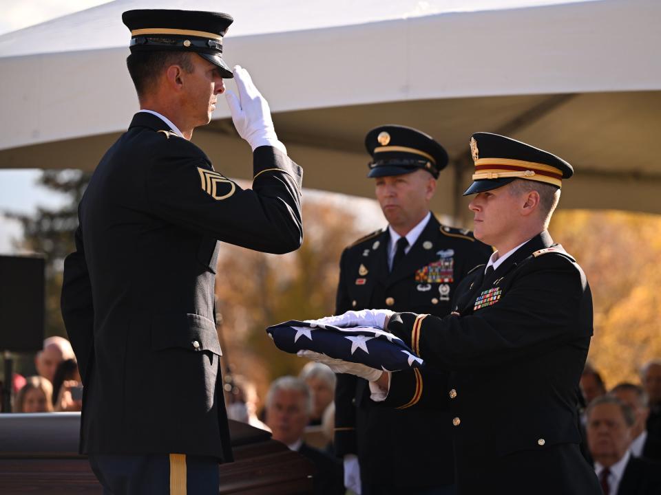 Military members conduct a flag presentation at President M. Russell Ballard’s graveside service in the Salt Lake City Cemetery on Friday, Nov. 17, 2023. | Scott G Winterton, Deseret News