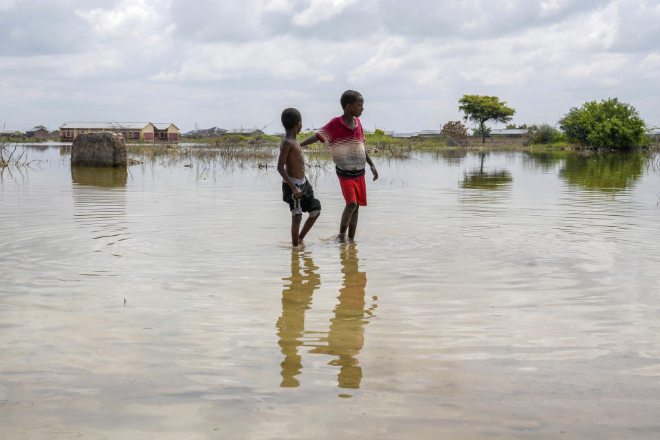 FILE - Children walk in a flooded field in Mandera County, Kenya, Dec. 13, 2023. The National Oceanic Atmospheric Administration Thursday, June 13, 2024, pronounced dead the El Nino that warms parts of the central Pacific. (AP Photo/Brian Inganga, File)