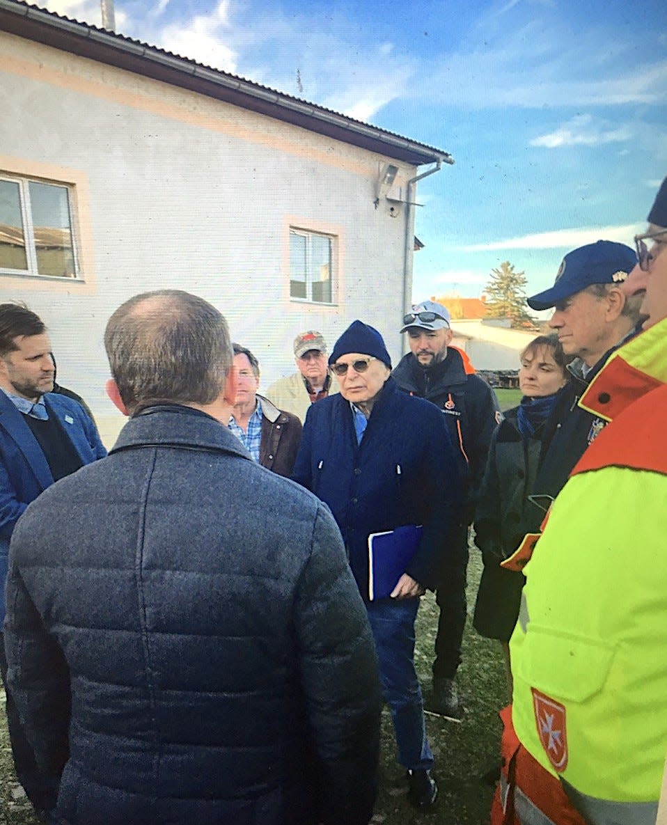 Ambassador Earle Mack, Tom Quick and former New York Gov. George Pataki meet with the ground team at a refugee center.