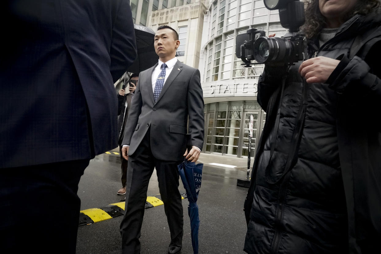 NYPD officer Baimadajie Angwang,, a naturalized U.S. citizen born in Tibet, leaves Brooklyn's Federal court after a judge dismissed spy charges against him, Thursday Jan. 19, 2023, in New York. Federal prosecutors dropped charges against Angwang, who authorities had initially accused of spying on independence-minded Tibetans on behalf of the Chinese consulate in New York. (AP Photo/Bebeto Matthews)