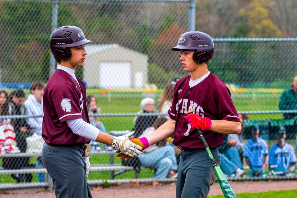 Bishop Stang's Brock Winslow is congratulated by a teammate.