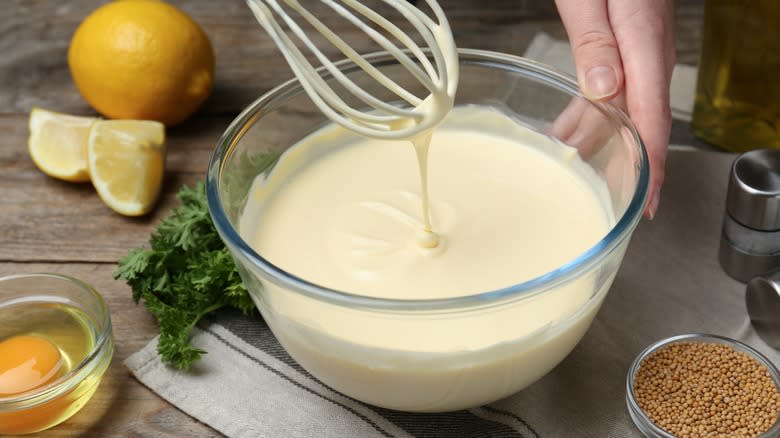 whisking mayonnaise in bowl