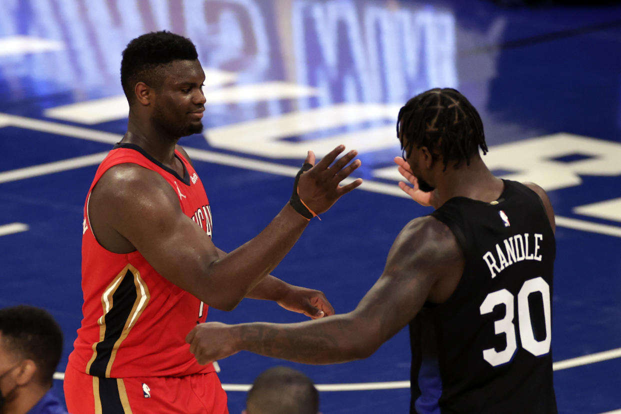 New Orleans Pelicans forward Zion Williamson, left, shakes hands with New York Knicks forward Julius Randle.