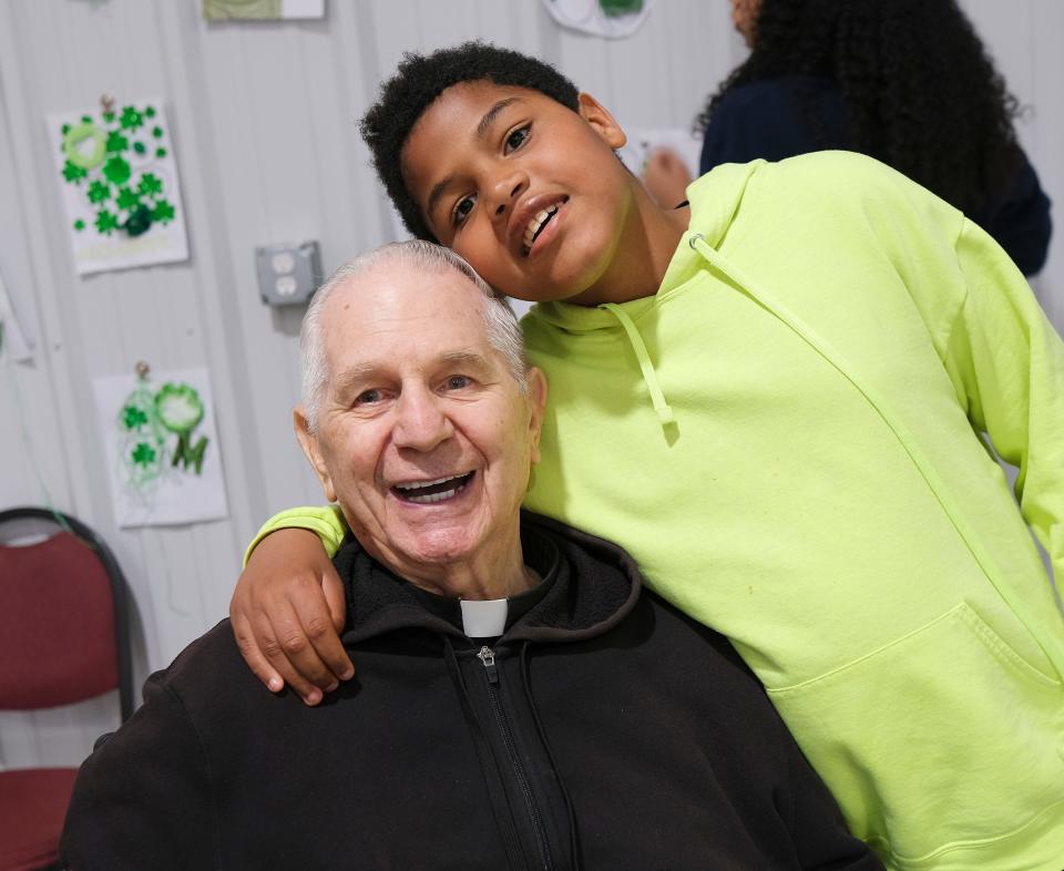 Josiah G., standing, poses for a picture with the Rev. Paul Zahler, a Benedictine monk and Catholic priest, during Camp Benedictine's spring camp for individuals with special needs at the program's new facility in McLoud.