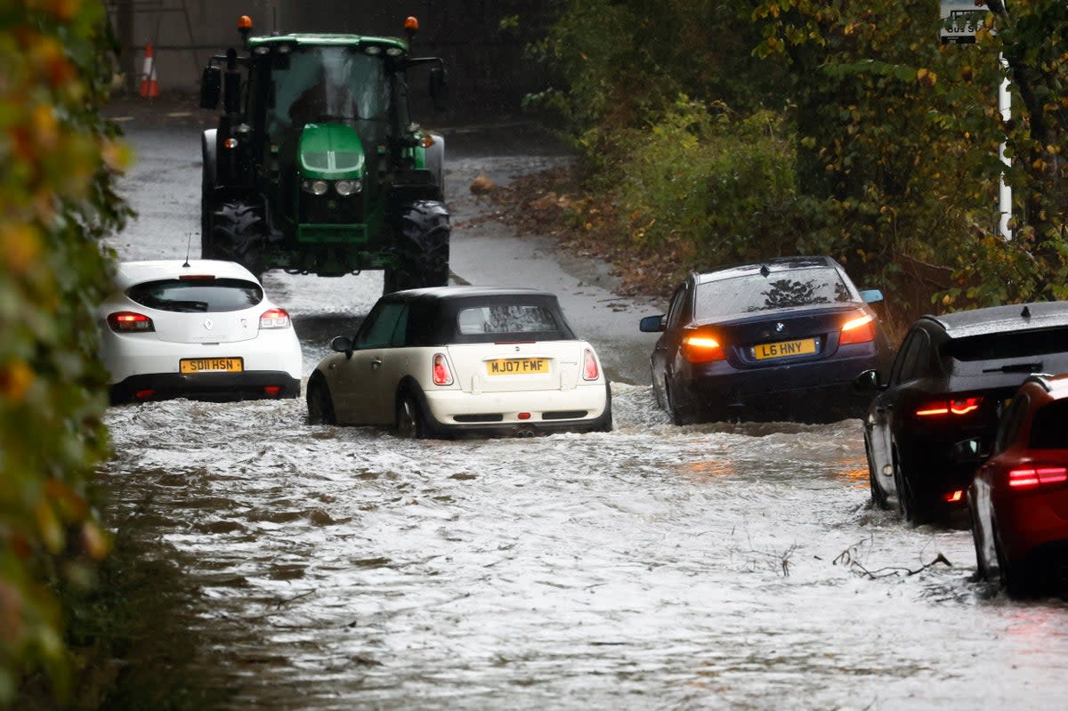 Cars in flood water in Dumbarton, Scotland, on Saturday  (Getty Images)