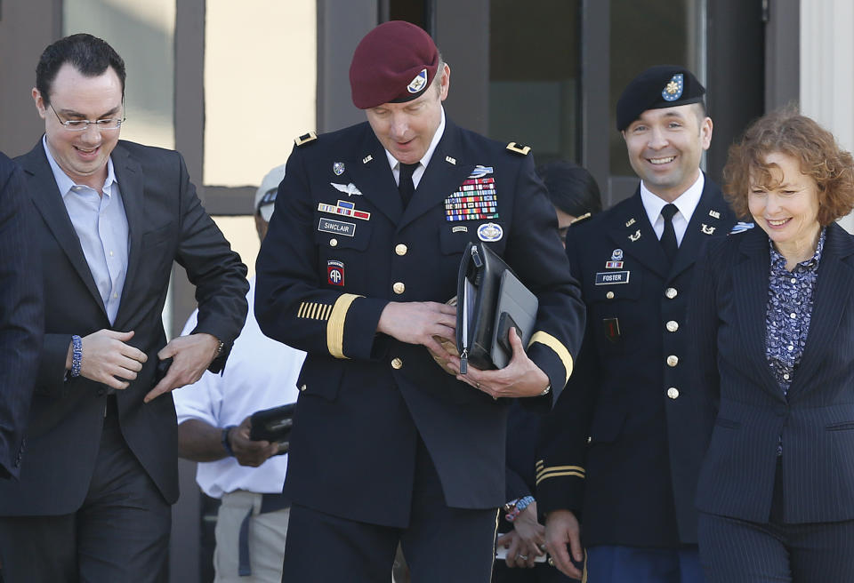 Brig. Gen. Jeffrey Sinclair, center, who admitted to inappropriate relationships with three subordinates, leaves the courthouse after being sentenced at Fort Bragg, N.C., Thursday, March 20, 2014. Attorneys Ellen Brotman, right, and Maj. Sean Foster, along with Josh Zeitz, left, who handled Public Relations for the defense, are by his side. Sinclair was reprimanded and docked $20,000 in pay Thursday, avoiding jail time in one of the U.S. military's most closely watched courts-martial. (AP Photo/Ellen Ozier)