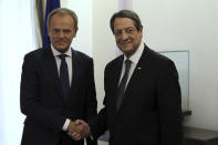 Cyprus' President Nicos Anastasiades, right, shakes hands with European Council President Donald Tusk during their meeting at the presidential palace in divided capital Nicosia, Cyprus, Friday, Oct. 11, 2019. Tusk is in Cyprus for one-day visit. (Yiannis Kourtoglou/Pool Photo via AP)