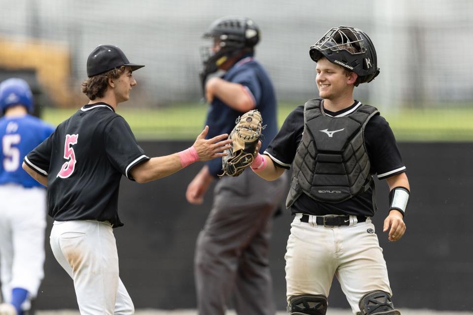 Kent Roosevelt pitcher Teddy Maccarone and catcher Ryan Schromm celebrate after the inning during Friday’s game against the Ravenna Ravens in Kent, OH.