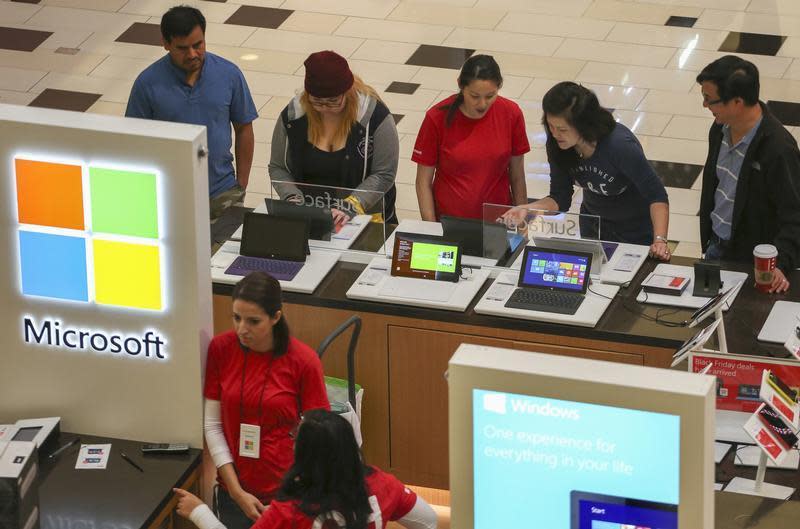 Black Friday shoppers check out Microsoft Surface tablets at the Glendale Galleria in Glendale, California November 29, 2013. REUTERS/Jonathan Alcorn/Files