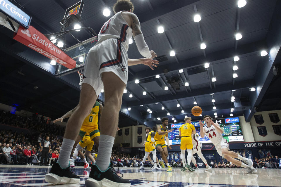 Saint Mary's guard Logan Johnson (0) inbounds the ball to teammate Alex Ducas (44) during the first half of an NCAA college basketball game against San Francisco, Thursday, Feb. 2, 2023, in Moraga, Calif. (AP Photo/D. Ross Cameron)